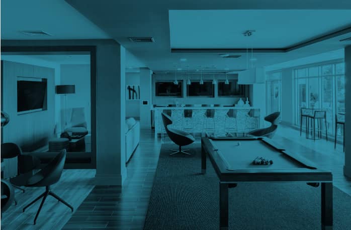 a living room with a pool table and chairs.